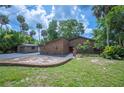Charming brick home featuring a landscaped yard, mature trees, and a brick mailbox at 6281 Halabrin Rd, Haines City, FL 33844