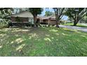Inviting single-story home with beautiful landscaping and a well-manicured lawn at 6342 Butternut Dr, Lakeland, FL 33813