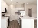 Bright kitchen featuring white cabinets, stainless steel appliances, ample counter space, and modern finishes at 7578 Sw 107Th Ln, Ocala, FL 34476
