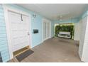Welcoming front porch with swing, ceiling fan, and beautiful wood flooring at 817 College Ave, Lakeland, FL 33801