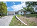Delightful one-story home showcases a lush green lawn and a convenient two-car garage at 818 Woodward St, Lakeland, FL 33803