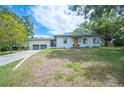 Attractive one-story home boasts a well-kept lawn and a two-car garage at 818 Woodward St, Lakeland, FL 33803