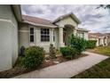Attractive single Gathering home featuring neat landscaping, a decorative fountain, and a covered front entry at 8323 Greystone Dr, Lakeland, FL 33810