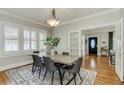 Elegant dining room with large windows, modern lighting, and an open floor plan at 838 S Tennessee Ave, Lakeland, FL 33801