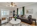 Comfortable living room with a large sofa, stylish decor, and hardwood floors at 838 S Tennessee Ave, Lakeland, FL 33801