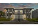Elegant two-story duplex with a paver driveway, private balconies, and exterior lighting at 1172 Windjammer Dr, Lakeland, FL 33803