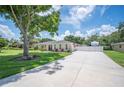 Exterior showing long driveway leading to an RV parking spot and a single-story home at 1307 Fairlee St, Lakeland, FL 33813