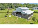 Spacious barn with metal roof, wooden siding, and fenced enclosure at 1385 Ewell Rd, Lakeland, FL 33811