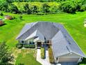 Stunning aerial view of home showcasing the roof, spacious lot, and verdant surroundings at 1531 Blue Sky Blvd, Haines City, FL 33844