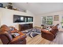 Inviting living area features comfortable leather seating, large screen TV, and backyard views at 1531 Blue Sky Blvd, Haines City, FL 33844