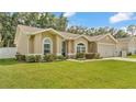 Attractive single-level home with a lush green lawn and a welcoming, blue-accented entrance at 1746 Grey Fox Dr, Lakeland, FL 33810