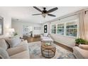 Bright living room with modern furniture, large windows, hardwood floors, and stylish decor at 2110 Bristol Ave, Lakeland, FL 33803