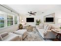 Bright living room featuring neutral furniture, a large window with natural light, and a ceiling fan at 2110 Bristol Ave, Lakeland, FL 33803