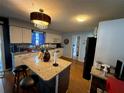 Stylish kitchen with granite countertops, an island with seating, and modern lighting fixtures at 2424 Bates Sw Ave, Winter Haven, FL 33880
