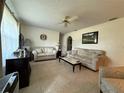 Comfortable living room with neutral tones, tile flooring, and ample seating for relaxation and entertainment at 2424 Bates Sw Ave, Winter Haven, FL 33880