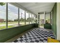 Relaxing screened porch with black and white rug, offering views of the neighborhood at 2711 Crutchfield Rd, Lakeland, FL 33805