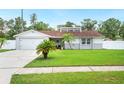 Charming single-story home with a well-manicured lawn and an attached two-car garage at 3080 Cross Fox Dr, Mulberry, FL 33860