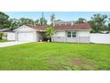 Charming single-story home with a well-manicured lawn and an attached two-car garage at 3080 Cross Fox Dr, Mulberry, FL 33860