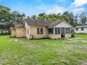 The exterior view showcases the home's roof, windows, and spacious backyard at 320 W Carver St, Lakeland, FL 33805