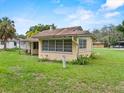 A view of the back of the home showing windows and greenery at 320 W Carver St, Lakeland, FL 33805