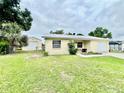 A single-story home with a detached garage and a spacious green lawn at 355 Pico Ct, Lakeland, FL 33809