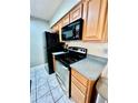 Modern kitchen with sleek black appliances and stylish countertop at 355 Pico Ct, Lakeland, FL 33809