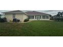 Expansive backyard showcasing a screened-in patio and lush green grass at 5480 Summerland Hills Dr, Lakeland, FL 33812