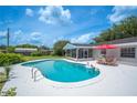 Backyard with a refreshing private pool, patio, and an umbrella-covered table at 5619 Stratford Ln, Lakeland, FL 33813