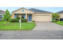 Beautiful home with manicured lawn, complemented by bright blue shutters and a two-car garage at 6819 Glenbrook Dr, Lakeland, FL 33811