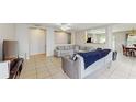 Bright living room featuring tile floors, neutral walls and comfortable seating, open to dining area with plenty of natural light at 7337 Hunters Greene Cir, Lakeland, FL 33810