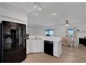 Bright kitchen featuring stainless steel appliances, a spacious island, and an adjacent dining area at 7642 Habersham Dr, Lakeland, FL 33810