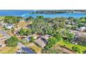 Stunning aerial view of a waterfront neighborhood featuring lush trees, charming homes, and serene blue waters at 841 E Valencia St, Lakeland, FL 33805