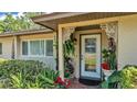 Inviting front entrance featuring decorative columns and landscaping, complemented by a glass paneled door at 841 E Valencia St, Lakeland, FL 33805