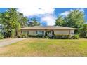 Charming single-story home with a well-maintained lawn, mature landscaping, and inviting curb appeal at 841 E Valencia St, Lakeland, FL 33805