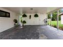 Large carport area with ample space for parking and storage, decorated with hanging plants at 848 17Th Ne Ter, Winter Haven, FL 33881