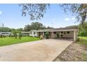 Wide view of a ranch-style home with a brick facade and a spacious carport at 848 17Th Ne Ter, Winter Haven, FL 33881