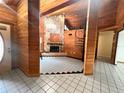 Spacious living room boasts wood walls, a stone fireplace, and a unique spiral staircase at 8504 N Campbell Rd, Lakeland, FL 33810