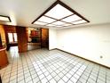 Open floor plan with unique spiral staircase adjacent to a stone fireplace and tiled flooring at 8504 N Campbell Rd, Lakeland, FL 33810