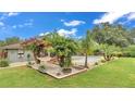 Backyard featuring a hammock, tropical plants, and a refreshing swimming pool perfect for relaxation and outdoor enjoyment at 8535 Plantation Ridge Blvd, Lakeland, FL 33809