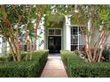 Charming front entrance with meticulously maintained hedges leading up to the front door at 943 Hamilton Place Ln, Lakeland, FL 33813