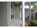 Covered front porch featuring tiled flooring and decorative columns at 943 Hamilton Place Ln, Lakeland, FL 33813