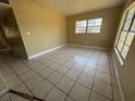This living room features tile flooring and a window at 1120 Ivy Ln, Bartow, FL 33830