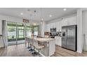 Gourmet kitchen featuring a spacious island with seating and stainless steel appliances at 1125 Mattie Pointe Blvd, Auburndale, FL 33823