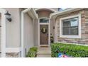 Welcoming front entrance with a decorative wreath, stone accents, and manicured landscaping at 1129 Bowline St, Winter Haven, FL 33880