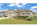 Charming single-Gathering home featuring stone accents, well-maintained landscaping, and an attached two-car garage at 1129 Bowline St, Winter Haven, FL 33880