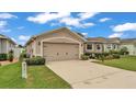 This property features a two-car garage and well-maintained landscaping at 1129 Bowline St, Winter Haven, FL 33880