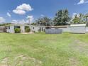 Large backyard with in-ground pool, shed, and expansive green lawn for outdoor activities at 1685 Kissengen Ave, Bartow, FL 33830