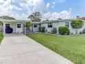 Beautifully landscaped front yard with a well-maintained lawn and attached carport on a sunny day at 1685 Kissengen Ave, Bartow, FL 33830
