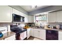 Functional kitchen design boasts white cabinets, modern appliances, durable countertops, and a window for natural light at 2333 Cheshire Pl, Lakeland, FL 33810