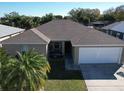 This aerial view showcases the house's layout, roof, and curb appeal from an elevated perspective at 244 Kings Pond Ave, Winter Haven, FL 33880